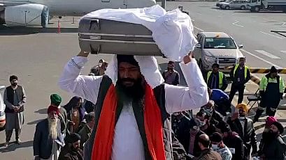 A Sikh delegation with the Holy book of Guru Granth Sahib boarding a plane for India under Operation Devi Shakti in Kabul, on 10 December 2021 | ANI Photo