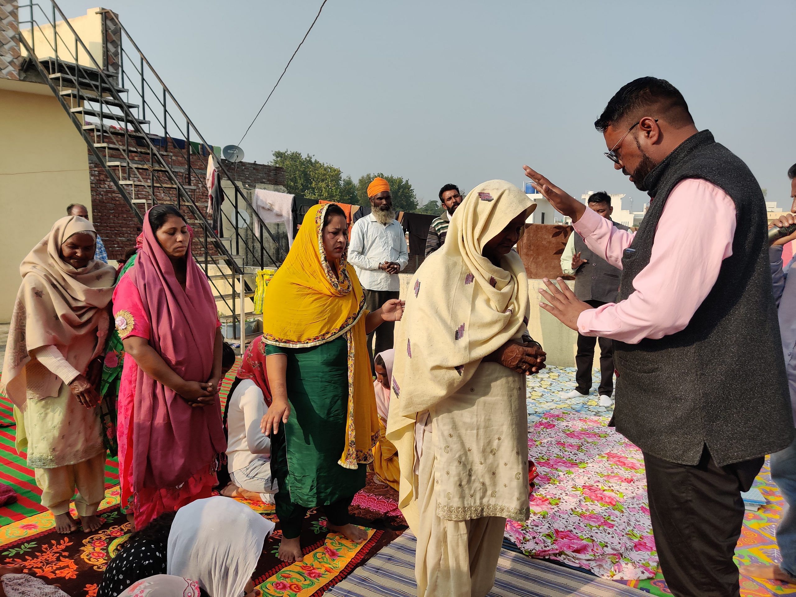 A pastor blesses women at a Pentecostal church opened in a house in Fatehgarh Churian, Gurdaspur | Shubhangi Misra | ThePrint