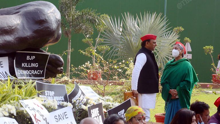 After Modi says ‘red cap is red alert’, SP MPs flaunt theirs at protest against RS suspensions