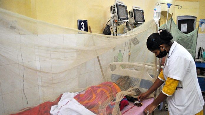 A nurse attends a dengue-infected patient at Tej Bahadur Sapru Hospital in UP's Prayagraj on 8 December 2021 | ANI photo