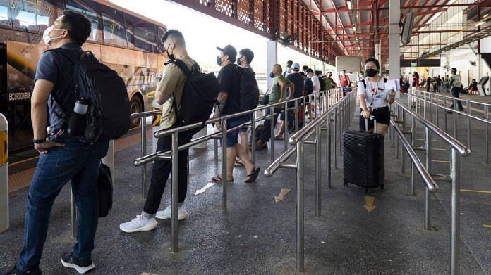 Passengers on the vaccinated travel lane wait for a bus to cross the Johor-Singapore Causeway at the Woodlands Bus Interchange in Singapore | Representational image | Bloomberg
