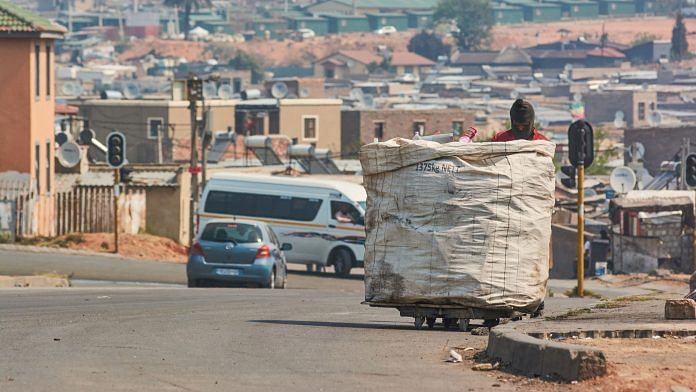 Representational image | A trash picker wheels a trolley along the street in the Alexandra township of Johannesburg | Photo: Waldo Swiegers | Bloomberg