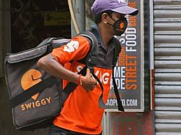 A swiggy delivery boy in front of a food outlet in Kolkata | Photo: Getty Images | NurPhoto