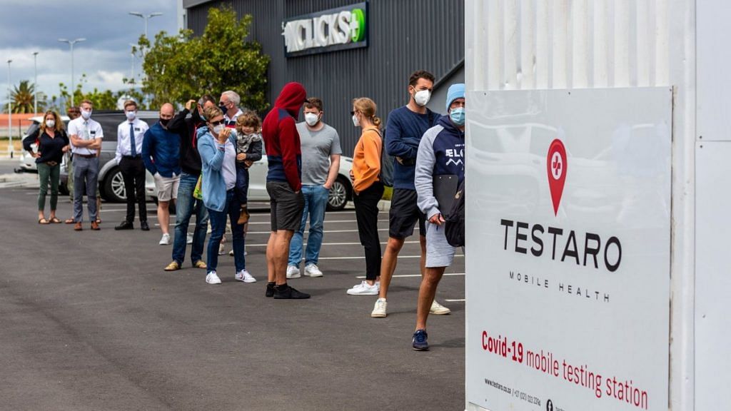 Residents queue by at a Covid-19 mobile testing site in Cape Town, South Africa, on 2 December 2021 | Bloomberg