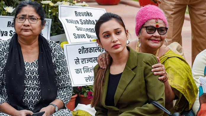 TMC MP Mimi Chakraborty with suspended MPs of Rajya Sabha sits on a dharna outside the Parliament building in New Delhi on 1 December 2021 | PTI Photo