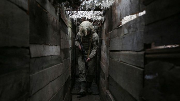 Ukrainian soldier walks along a trench on the frontline with Russia-backed separatists, not far from town of Avdiivka, Donetsk region, on 10 December 2021 | Photographer: Anatolii Stepanov/AFP/Getty Images via Bloomberg