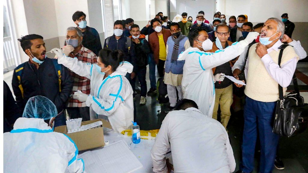 Medics collect swab samples of passengers for Covid-19 test at Rani Kamlapati railway station in Bhopal on 7 December 2021|PTI