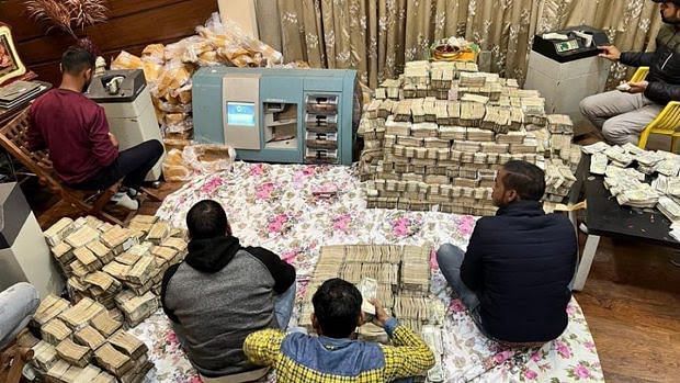 Money seized in the raid being counted | By special arrangement