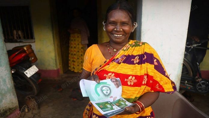 A tribal woman shows the BSKU smart health card | Photo: Manisha Mondal | ThePrint
