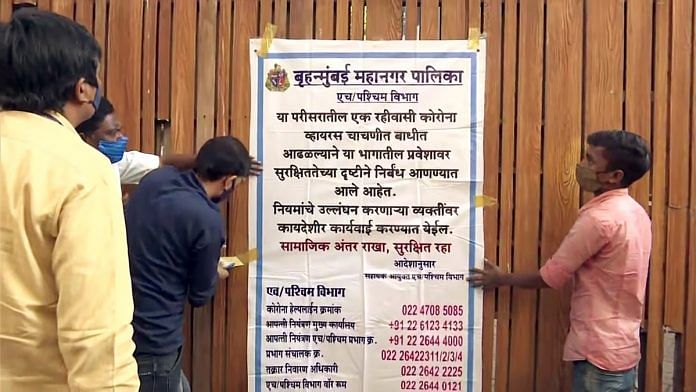 BMC workers put up a poster outside the apartment building of Bollywood actress Kareena Kapoor Khan to conduct Covid-19 testing, in Mumbai on 14 December. | Photo: ANI