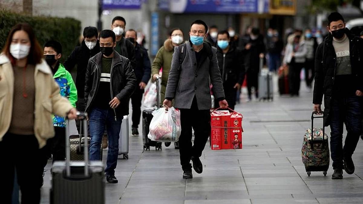 File photo of people in masks outside the Shanghai railway station in China | Representational Image | ANI