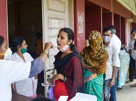 A health worker collects swab samples of a woman for Covid test in Karad, Maharashtra, on 11 December 2021 | PTI