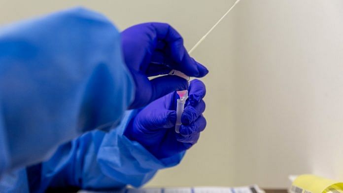 A health worker prepares a coronavirus swab test at a Testaro Covid testing site in the Goodwood district of Cape Town, South Africa | Bloomberg