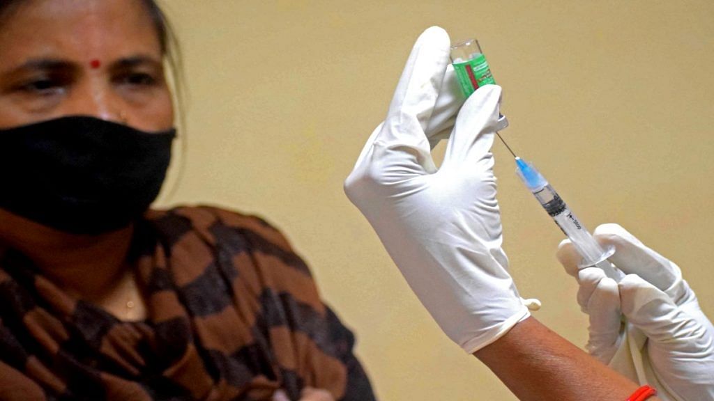A healthcare worker vaccinates a woman in Prayagraj. | File photo: ANI
