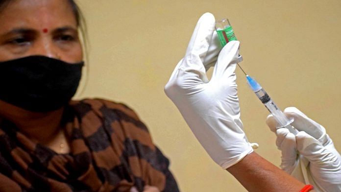 A healthcare worker vaccinates a woman in Prayagraj. | File photo: ANI