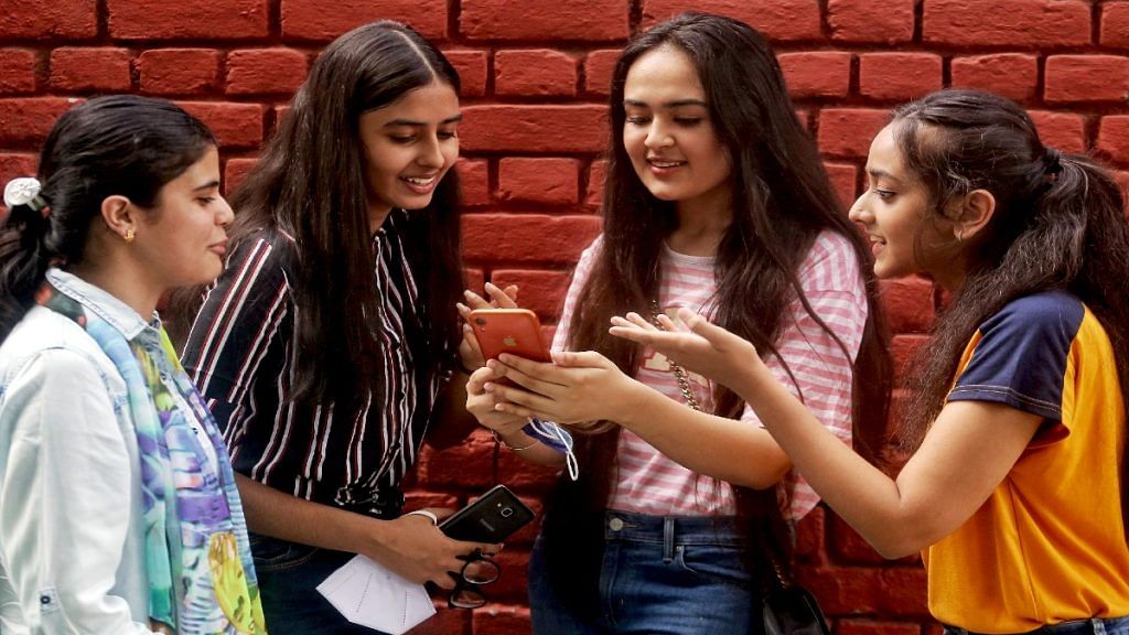 Girls check their exam results on a mobile phone, in New Delhi. | Representational image: ANI