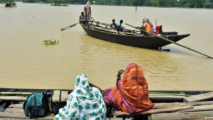 Representational image | Residents using boats to cross a waterlogged area due to a flood, Ghatal, West Bengal, August 2021 | ANI