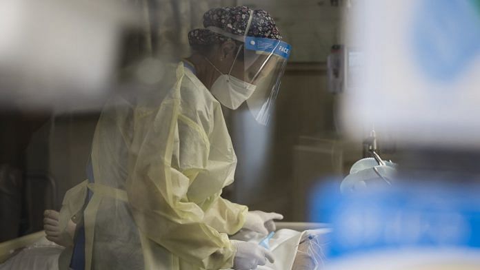 A healthcare worker treats a patient inside a negative pressure room in the Covid ICU at Freeman Hospital West in Joplin, US | Representational image | Bloomberg