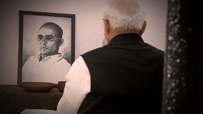 File photo | PM Modi in front of a picture of Savarkar | Twitter/Narendra Modi