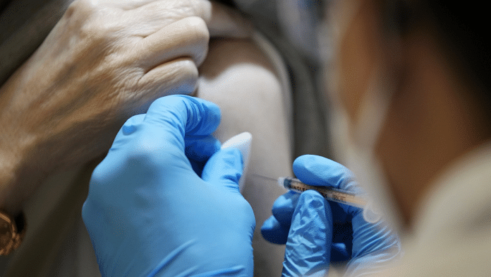 A healthcare worker administers a Covid vaccine booster shot at a mass vaccination site | Representational image| Bloomberg