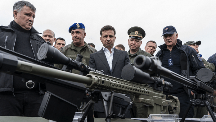 Volodymyr Zelenskiy (3rd from left), inspects sniper rifles during a drill in Stare, Ukraine | Bloomberg