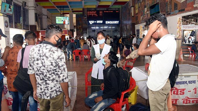 A healthcare worker collects a swab sample of passengers for Covid test at Patna Railway Station | ANI File Photo