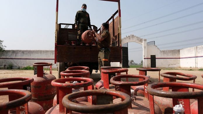 Workers load LPG cylinders onto a delivery truck at a village warehouse in Greater Noida | Photo: T. Narayan | Bloomberg Photo