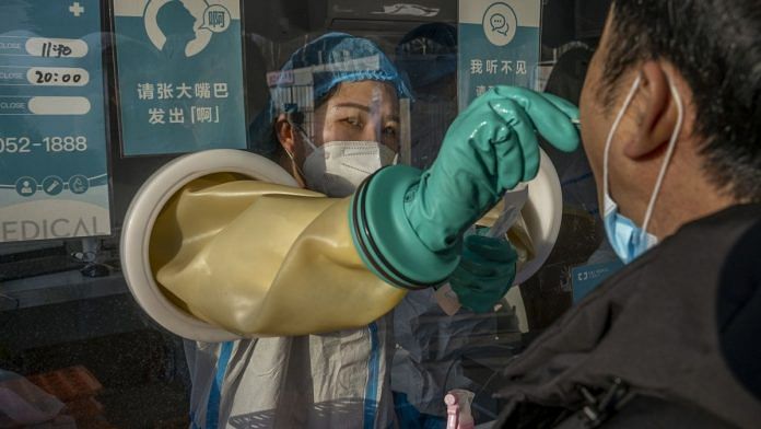 A medical worker performs a PCR test in Beijing | Representational image | Bloomberg