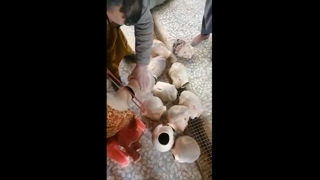 Screenshot from the viral video showing a shopkeeper behead mannequins in Herat, Afghanistan | Twitter | @QaderiHomeira