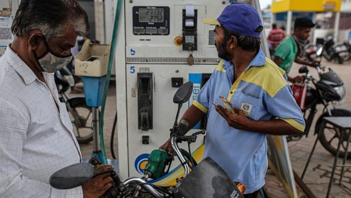 Refueling motorcycles at a Bharat Petroleum Ltd. gas station in Jamnagar, Gujarat | Bloomberg