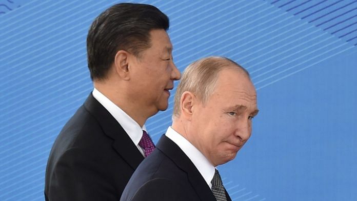 Russian President Vladimir Putin and Chinese President Xi Jinping walk as they attend a meeting of the Shanghai Cooperation Organisation (SCO) Council of Heads of State in Bishkek on June 14, 2019 | Photographer: Vyachesalav Oseledko/AFP/Getty Images via Bloomberg