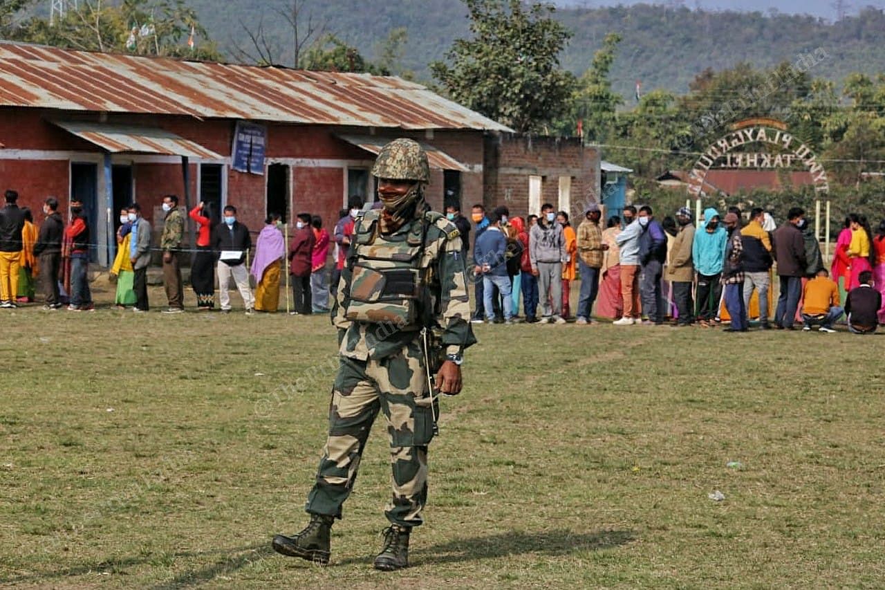 Security personal standing outside the polling booth at Takhel primary school in Lamlai constituency | Praveen Jain | ThePrint