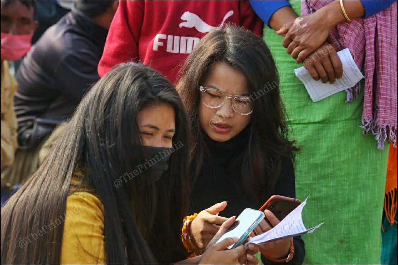 Girls sitting outside a polling booth at Takhel primary school in Lamlai constituency | Praveen Jain | ThePrint