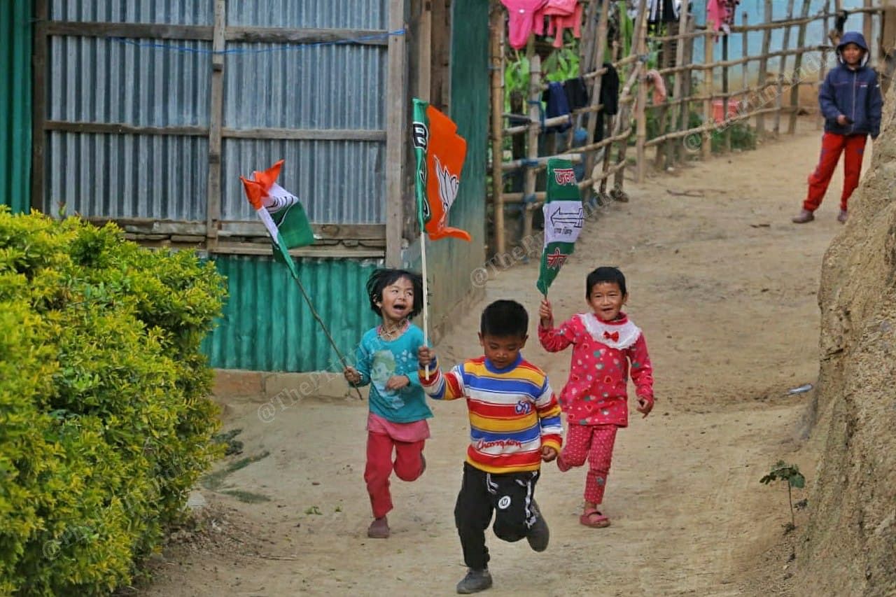 Children run with flags of different political parties | Photo: Praveen Jain | ThePrint