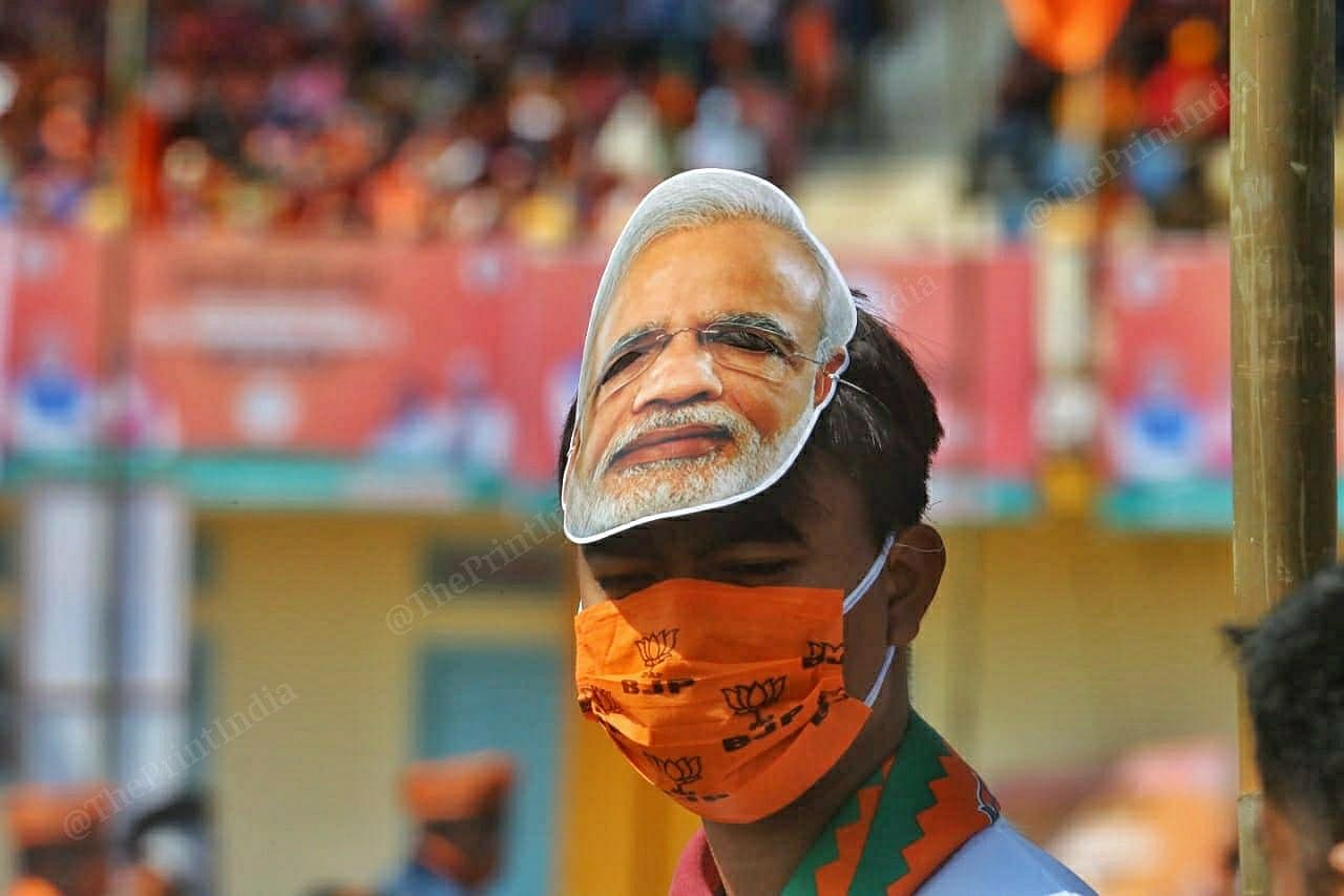 A person at the rally wearing Modi mask | Photo: Praveen Jain | ThePrint