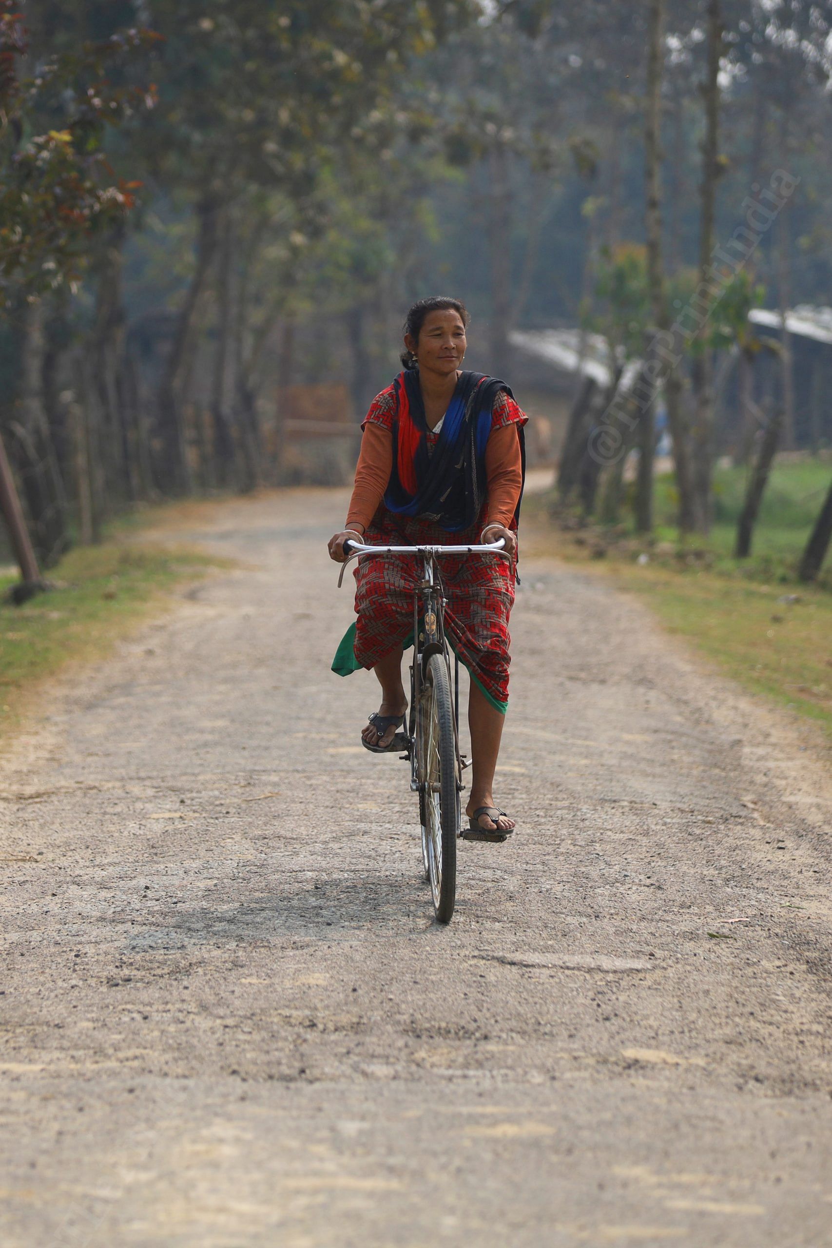 A woman rides bicycle on the streets on village | Photo: Manisha Mondal | ThePrint