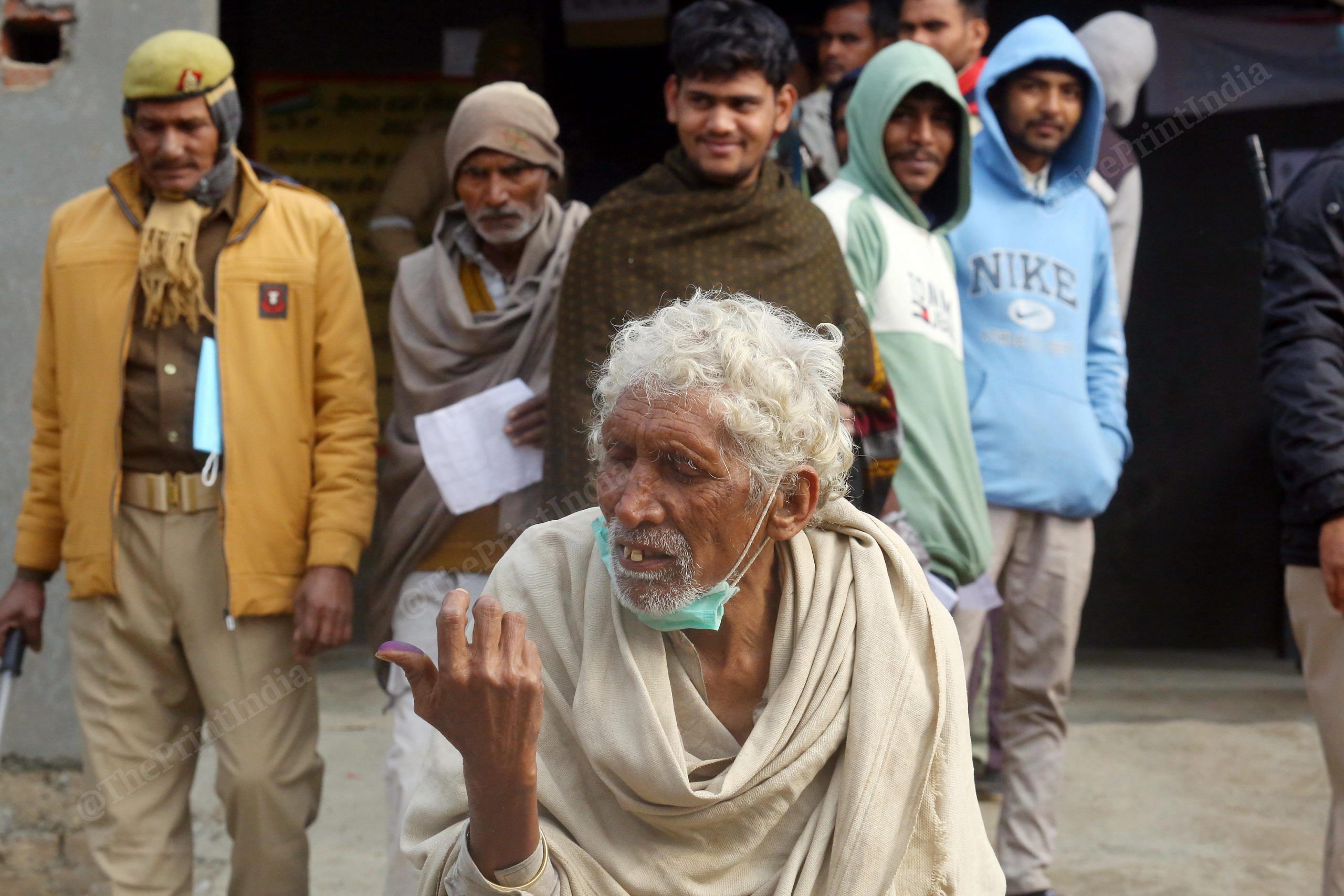 A voter holds up his inked finger after casting his vote at a polling booth in Basoli villages Harijan Chopal area | Praveen Jain | ThePrint