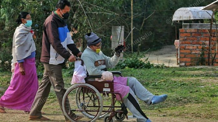 Family member taking his physically disabled relative to cast their vote at Takhel primary school in Lamlai constituency | Praveen Jain | ThePrint