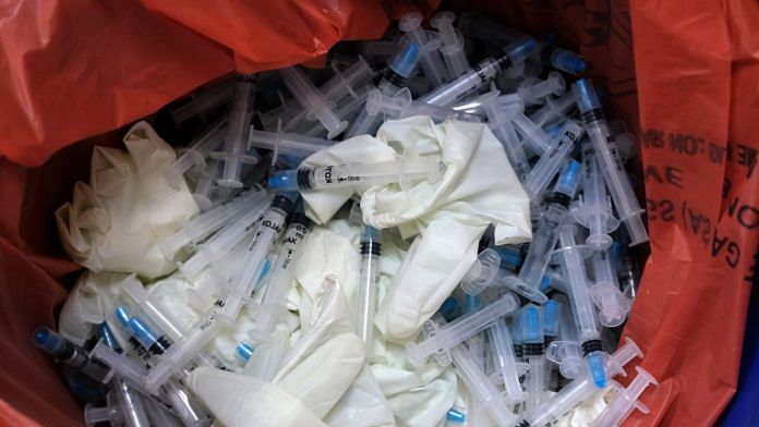 Disposed syringes and rubber gloves used for administering the Covishield vaccine at a vaccination centre in New Delhi | Representational image | Bloomberg