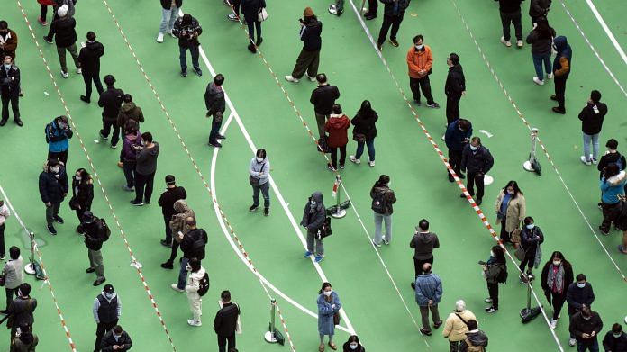 Residents queue at a Covid-19 testing facility in Hong Kong on 23 February 2022 | Photo: Chan Long Hei | Bloomberg