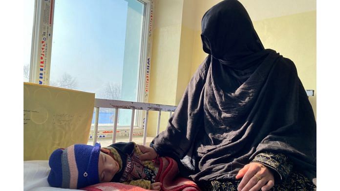 Madina with her 8-month-old son, Seraj, treats for severe acute malnutrition and heart problems at a hospital in Afghanistan | Twitter/@UNICEFAfg