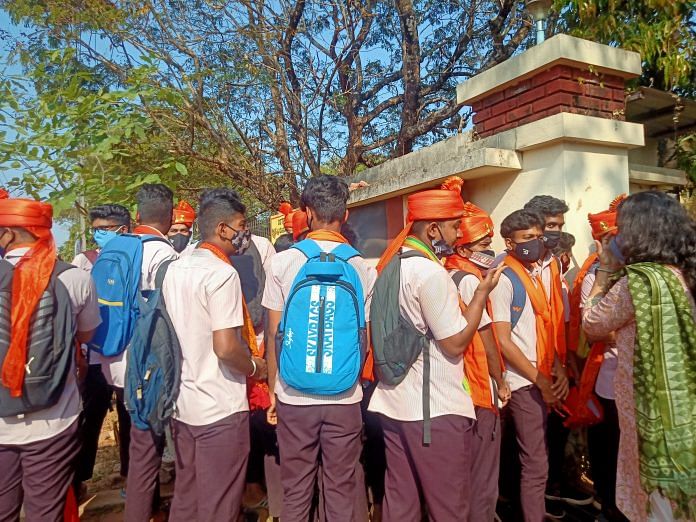 Students in saffron scarves and headwear arrive at Mahatma Gandhi Memorial College in Udupi on 8 February. | Anusha Ravi Sood | ThePrint