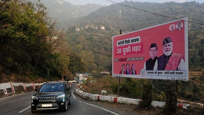 PM Narendra Modi and Uttarakhand CM Pushkar Singh Dhami on a BJP hoarding put up along the Dehradun-Mussoorie road | Suraj Singh Bisht | ThePrint