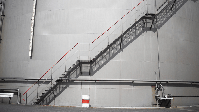 A staircase runs up the side of a storage silo at the Erik Walther GmbH oil terminal in Schweinfurt, Germany | Photographer: Alex Kraus/Bloomberg