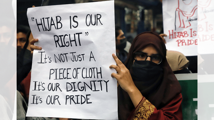 A demonstrator holds a placard during a protest march in solidarity with girl students of Karnataka over 'hijab' issue at Shaheen Bagh in New Delhi, on 9 February 2022 | ANI photo