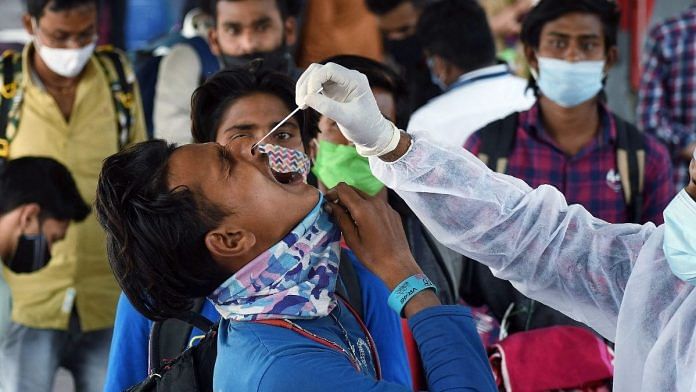 A BMC health worker collects a nasal swab sample of a passenger for a Covid-19 test on their arrival at Dadar railway station, in Mumbai, on 11 February 2022 | Photo: ANI