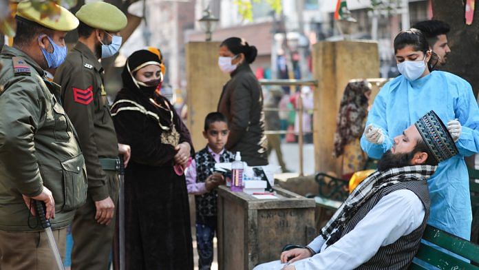 A healthcare worker conducts Covid-19 testing in Jammu on 13 February 2021| PTI Photo
