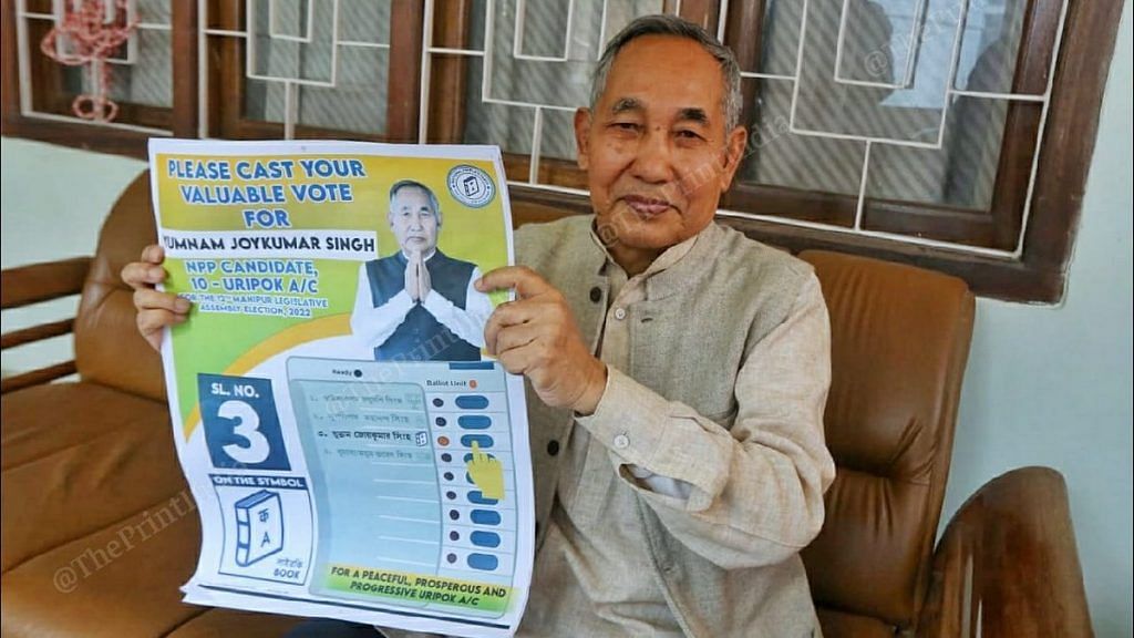 Manipur Deputy CM and former DGP Yumnam Joykumar Singh holds up his campaign poster | Photo: Praveen Jain | ThePrint