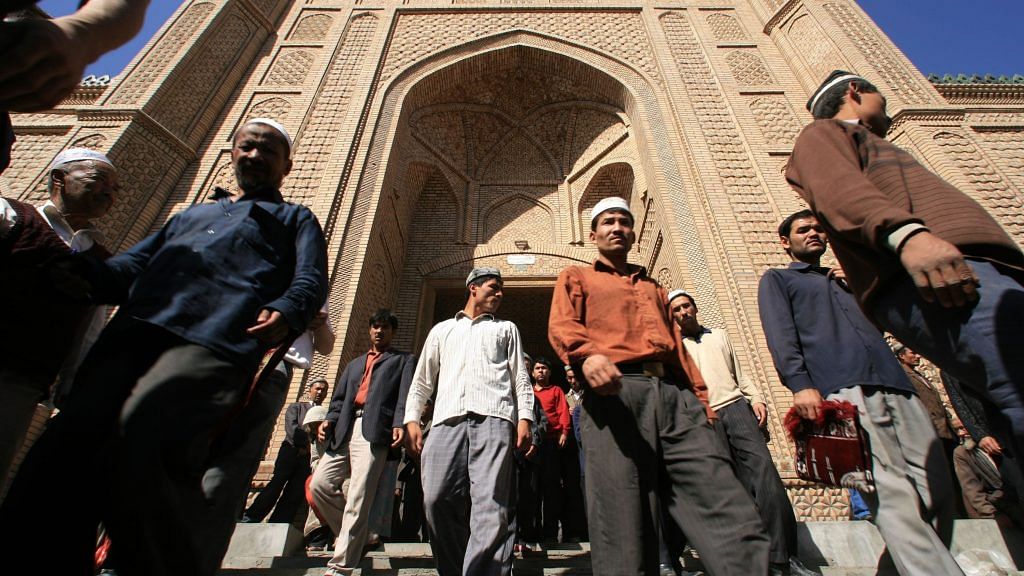 File photo of Muslims exiting Hetian mosque in Hetian, Xinjiang province, China in October 2006 | Photo: Lucas Schifres | Bloomberg