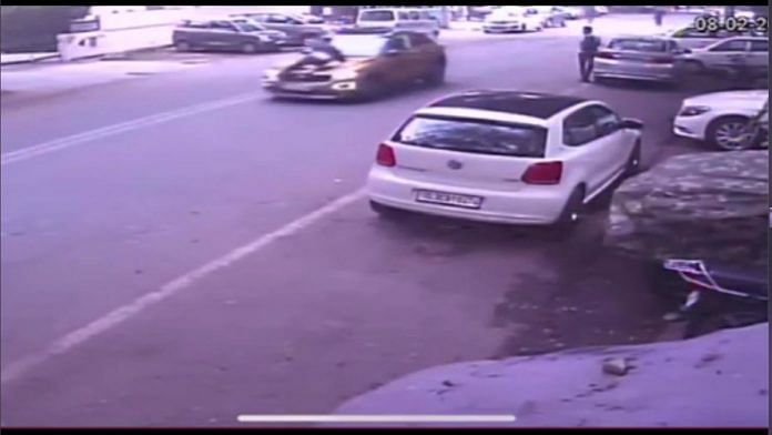 A screenshot of CCTV footage showing the Volkswagen moving with a man on its bonnet | By special arrangement